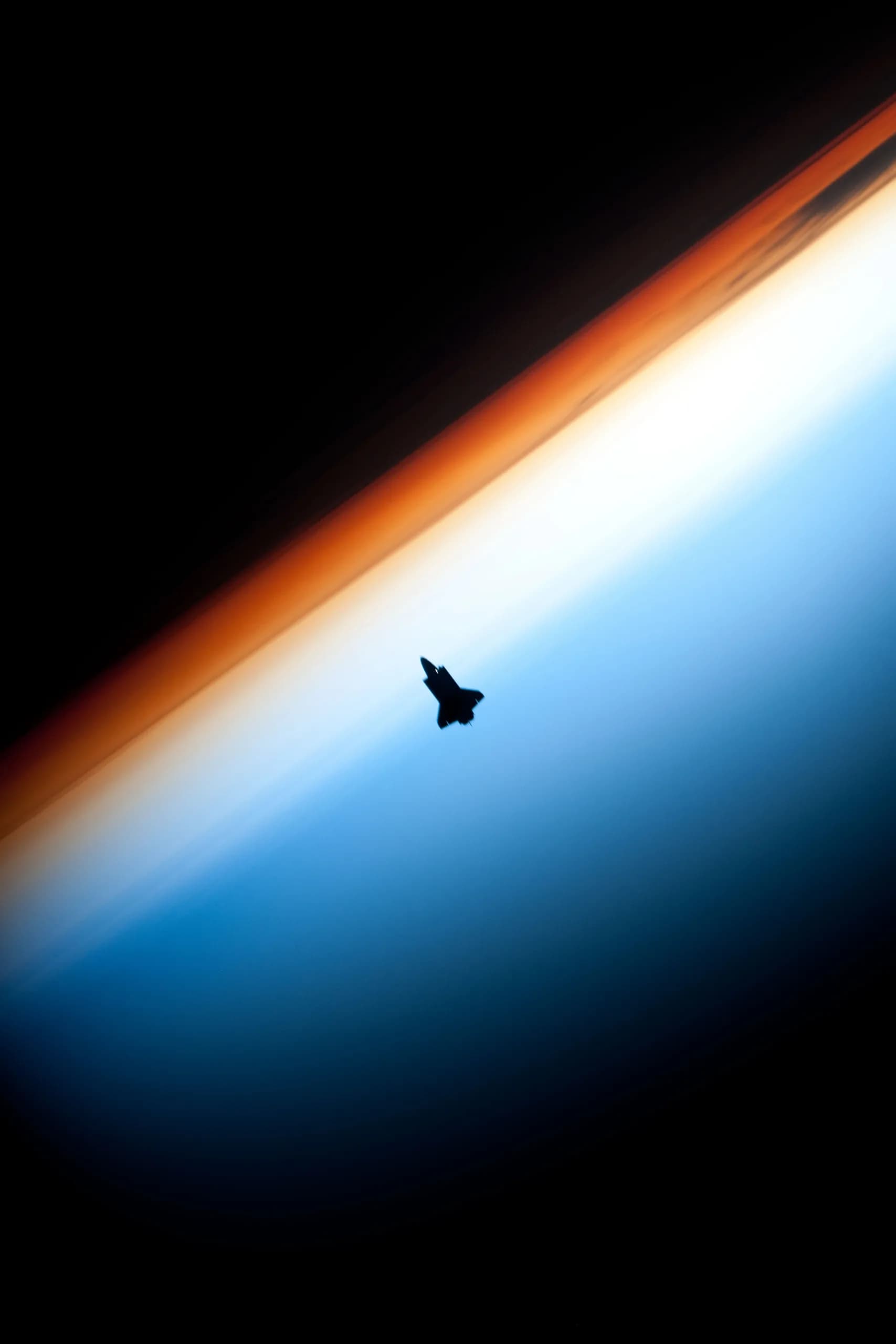 The Endeavour space shuttle silhouetted against the upper atmosphere